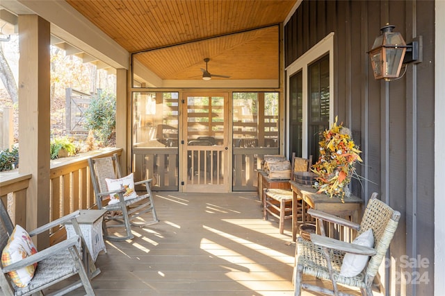 sunroom featuring ceiling fan, wood ceiling, and vaulted ceiling