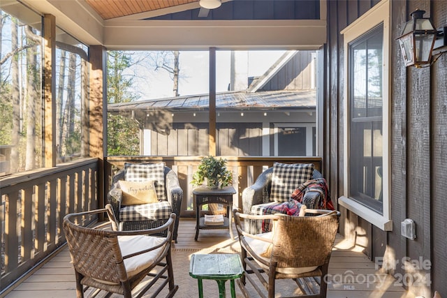 sunroom featuring plenty of natural light and vaulted ceiling