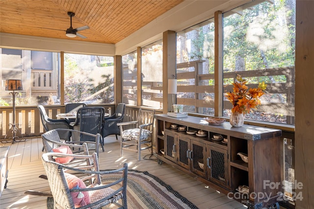 sunroom with a wealth of natural light, ceiling fan, wood ceiling, and vaulted ceiling