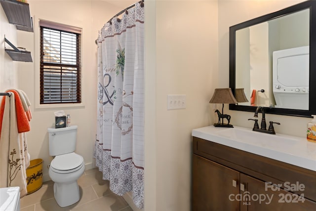 full bathroom featuring shower / bath combo, tile patterned floors, stacked washer / drying machine, vanity, and toilet