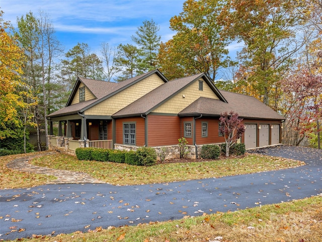 view of front of property with a garage and a porch