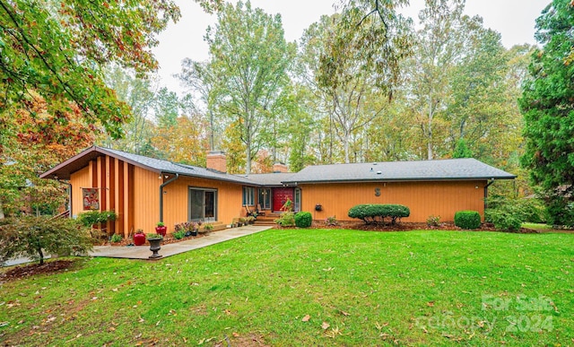 rear view of house with a yard and a patio area