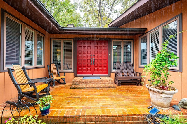 view of exterior entry featuring a porch