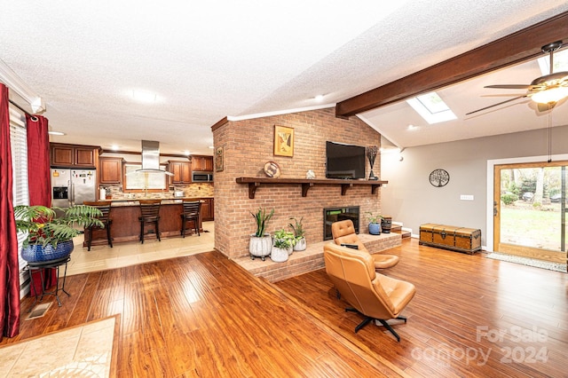 living room with light hardwood / wood-style floors and a textured ceiling