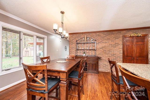 dining room with hardwood / wood-style floors, a healthy amount of sunlight, and brick wall