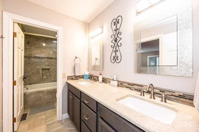 bathroom featuring vanity, tile patterned flooring, and tiled shower / bath combo