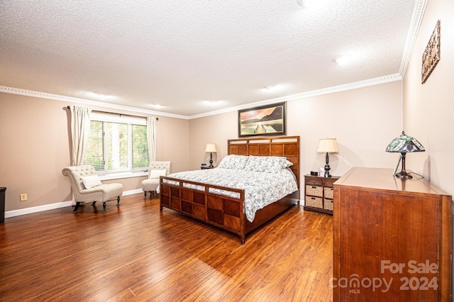 bedroom featuring a textured ceiling, hardwood / wood-style flooring, and ornamental molding