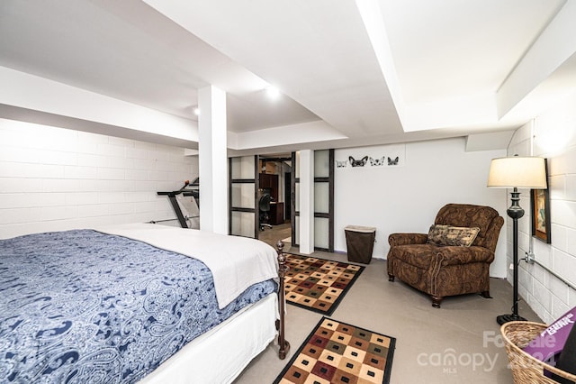 bedroom featuring concrete floors