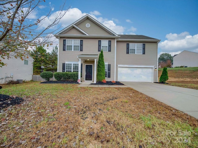 view of front of home with a garage, cooling unit, and a front lawn