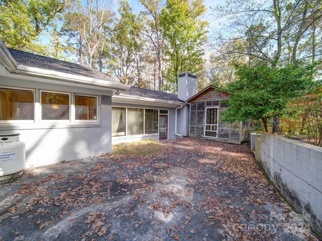 back of house featuring a sunroom