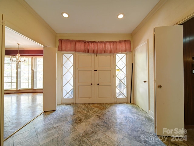 entrance foyer featuring crown molding and an inviting chandelier