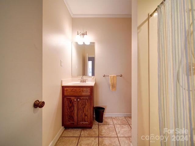 bathroom featuring tile patterned floors, vanity, crown molding, and walk in shower