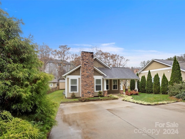 136 Lower Grassy Branch Rd, Asheville, NC 28805 - view of front of property featuring a chimney, a front lawn, and a porch