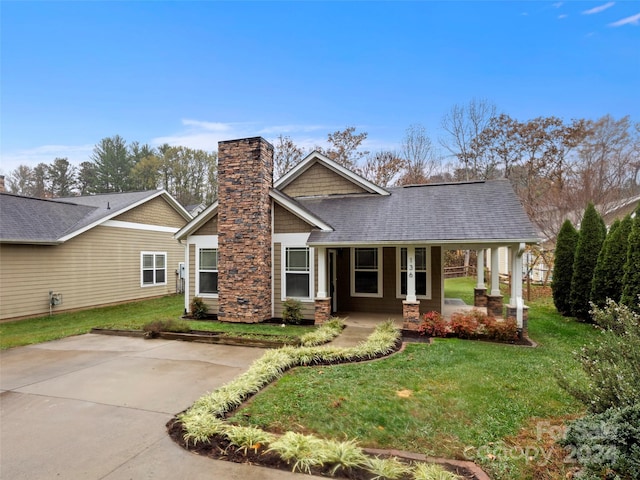 136 Lower Grassy Branch Rd, Asheville, NC 28805 - view of front of house featuring a chimney, a porch, a front lawn, and roof with shingles