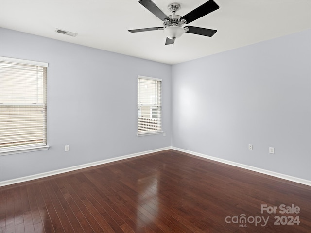 spare room featuring wood-type flooring and ceiling fan