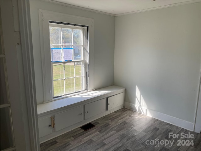 interior space with dark wood-type flooring and ornamental molding