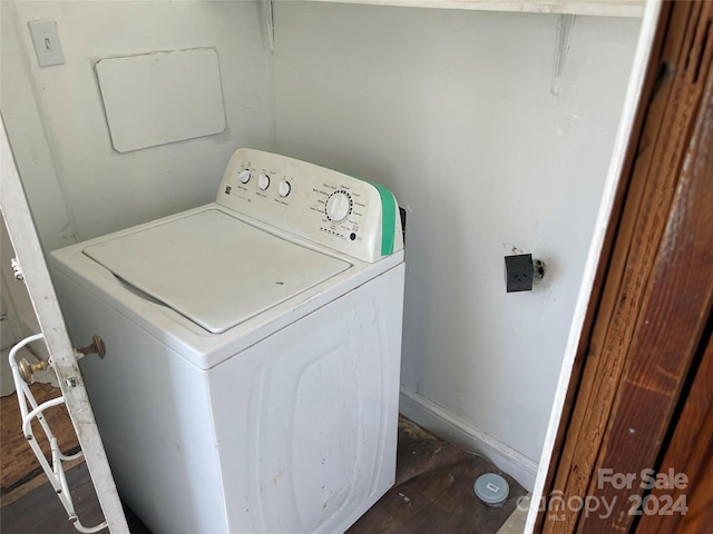 laundry room featuring dark wood-type flooring and washer / dryer