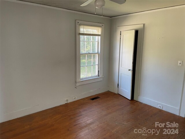 223 Chester Ave, Great Falls, SC 29055 - unfurnished room featuring wood finished floors, baseboards, crown molding, and a ceiling fan