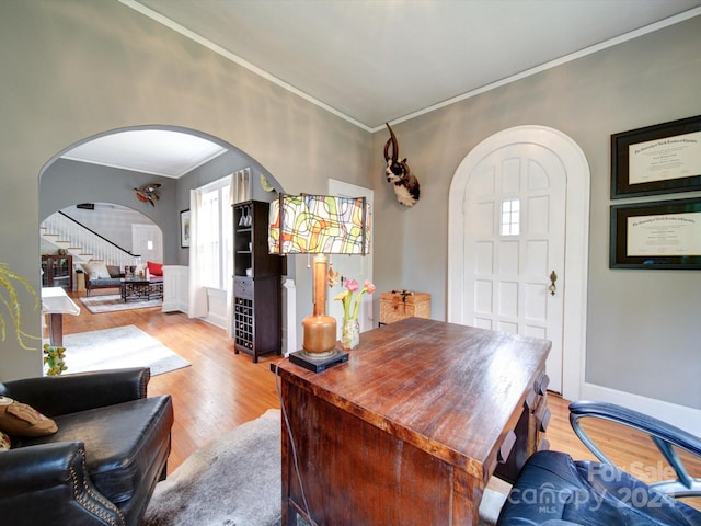 office with light hardwood / wood-style floors and crown molding