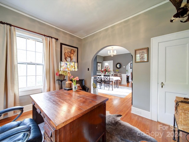 home office with light hardwood / wood-style floors and ornamental molding