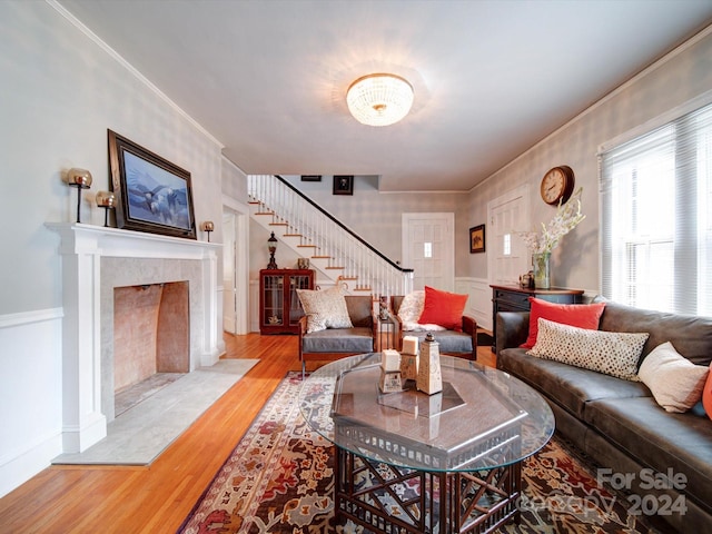 living room featuring light wood-type flooring and crown molding