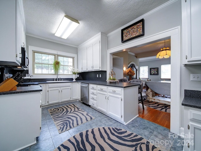 kitchen featuring a wealth of natural light, white cabinetry, kitchen peninsula, and crown molding