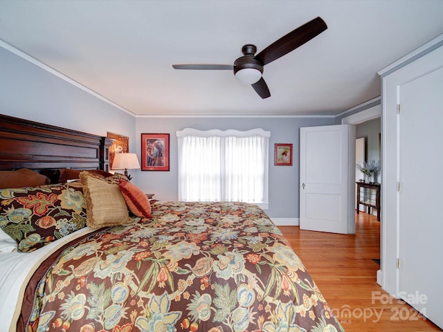 bedroom with light hardwood / wood-style floors, ceiling fan, and crown molding