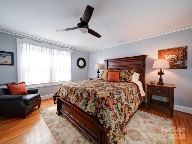 bedroom with ceiling fan, light hardwood / wood-style floors, and crown molding