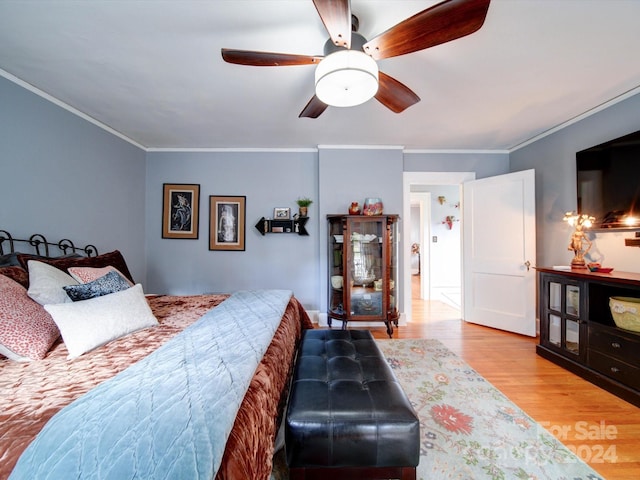 bedroom with ceiling fan, light wood-type flooring, and ornamental molding