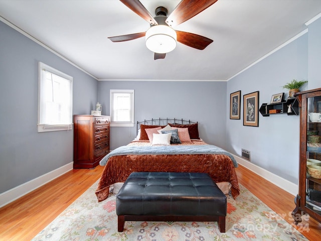 bedroom featuring ornamental molding, ceiling fan, and light hardwood / wood-style flooring