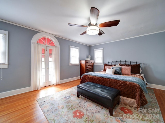 bedroom with ceiling fan, light hardwood / wood-style flooring, and ornamental molding