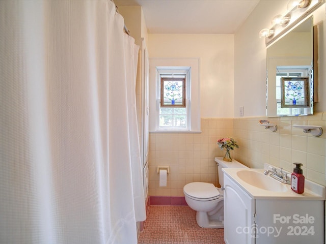 bathroom featuring tile walls, tile patterned flooring, vanity, and toilet