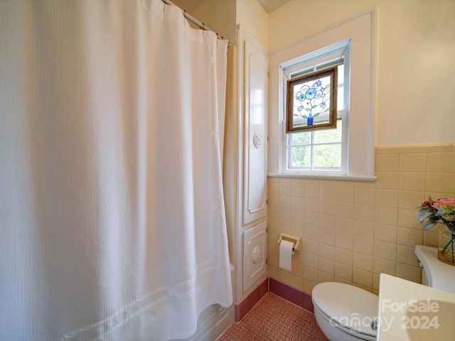 bathroom with toilet, shower / tub combo, tile walls, and tile patterned flooring