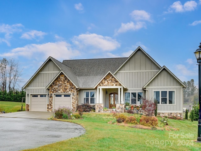 craftsman-style house with a garage and a front yard