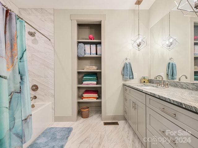 bathroom featuring shower / tub combo and vanity