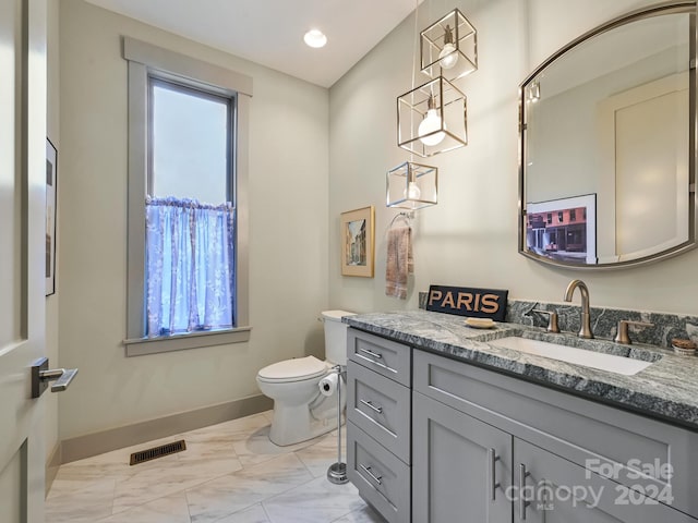 bathroom featuring vanity and toilet