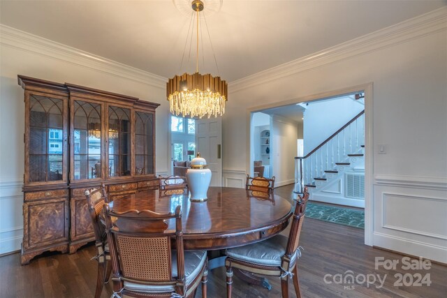 dining space featuring a chandelier, crown molding, and dark wood-type flooring