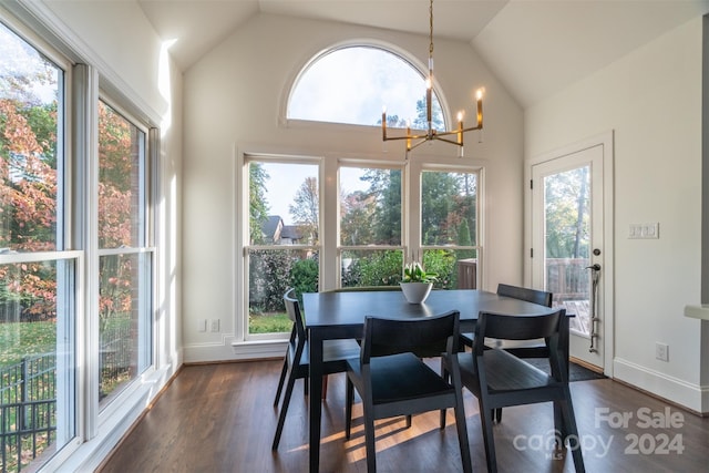 dining area with dark hardwood / wood-style flooring, an inviting chandelier, high vaulted ceiling, and a wealth of natural light