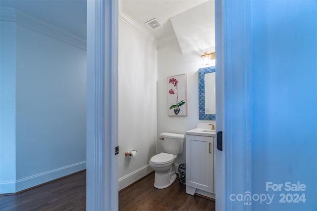 bathroom featuring crown molding, hardwood / wood-style floors, vanity, and toilet