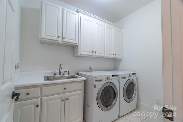 clothes washing area featuring cabinets, light tile patterned floors, separate washer and dryer, and sink