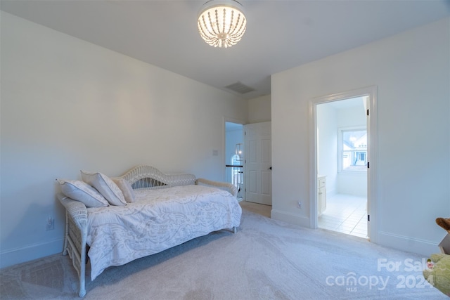 bedroom with connected bathroom and carpet floors