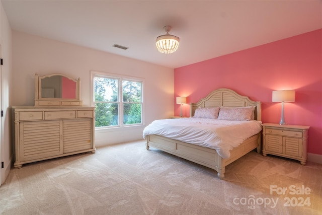 bedroom featuring light colored carpet