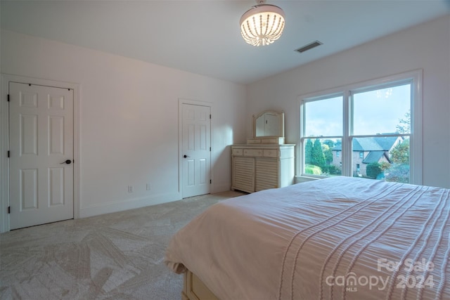 bedroom with light colored carpet