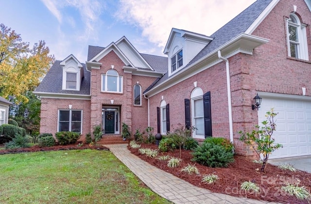 view of front property featuring a front yard and a garage