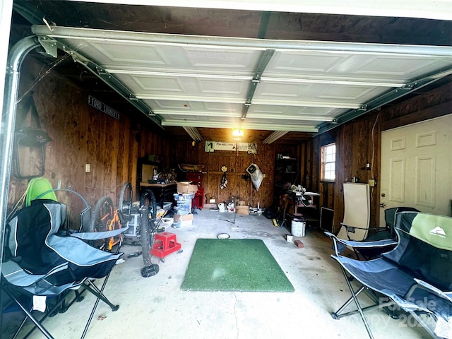 garage featuring wood walls