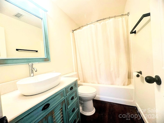 full bathroom with toilet, vanity, hardwood / wood-style flooring, and shower / bathtub combination with curtain