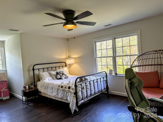 bedroom with ceiling fan and dark hardwood / wood-style floors