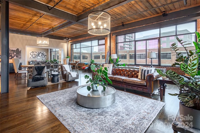 living room featuring dark hardwood / wood-style flooring, beamed ceiling, wood ceiling, and an inviting chandelier