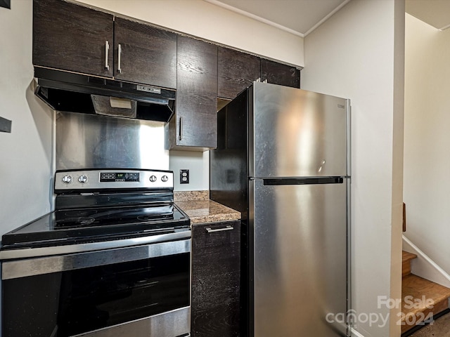 kitchen featuring dark brown cabinets, stainless steel appliances, and light stone countertops