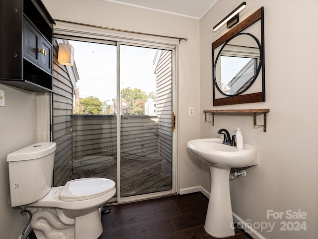 bathroom with toilet and wood-type flooring